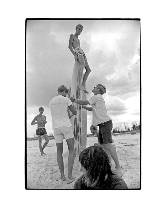 Kid sitting on surfboard while friends hold it up, Florida, 1969 — Limited Edition Print
