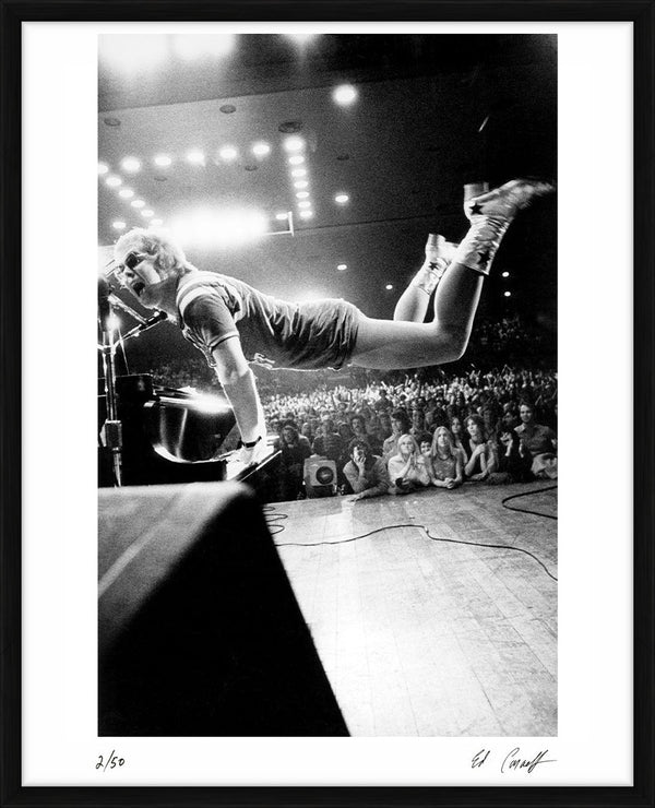 Elton John takes flight, 1970 — Limited Edition Print, framed - Ed Caraeff