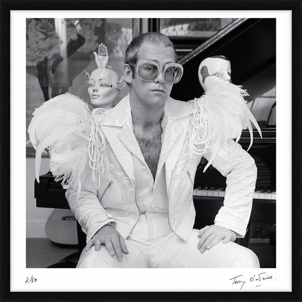 Elton John wearing a white feather suit, circa 1973 — Limited Edition Print, framed - Terry O'Neill