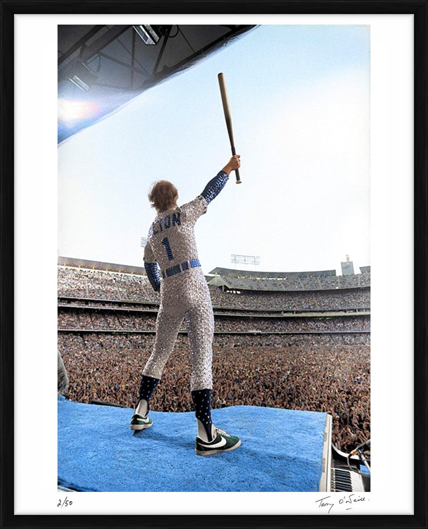Elton John standing on a piano (colourised), 1975 by Terry O'Neill – Limited Edition Print.