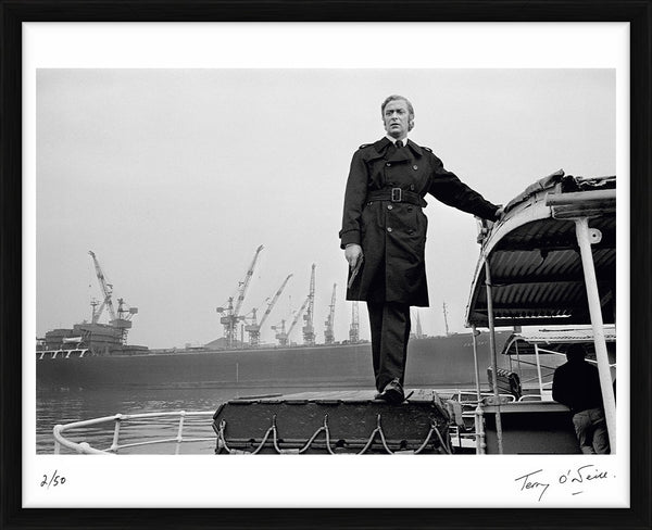 Michael Caine stands on a boat, 1970 — Limited Edition Print, framed - Terry O'Neill