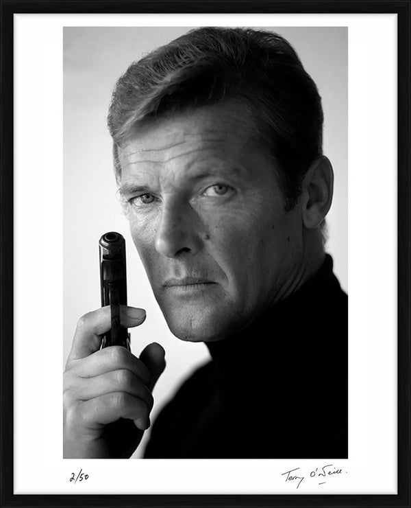 Roger Moore as James Bond, with his weapon of choice, December 1972 — Limited Edition Print, framed - Terry O'Neill