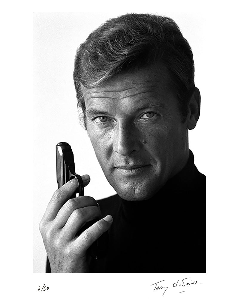 Roger Moore as James Bond poses with his weapon of choice, December 1972 by Terry O'Neill – Limited Edition Print.