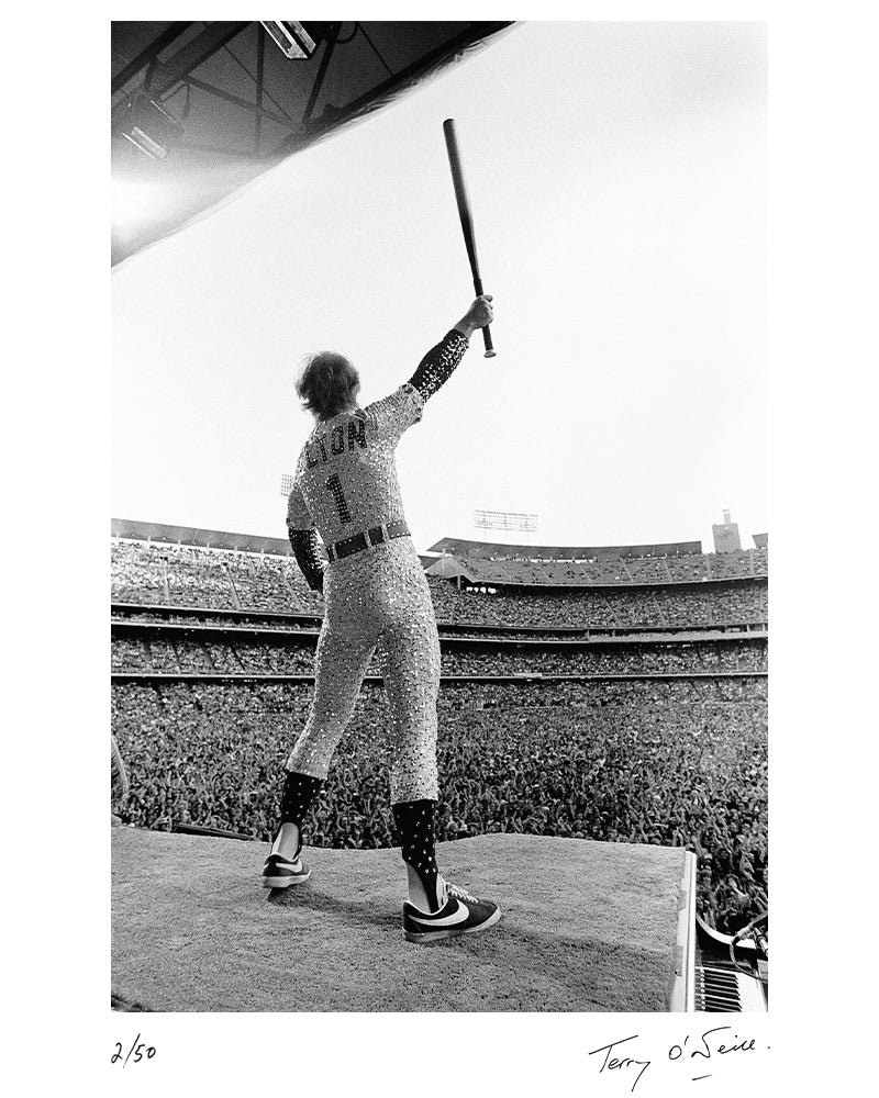 Elton John standing on a piano, 1975 — Limited Edition Print - Terry O'Neill