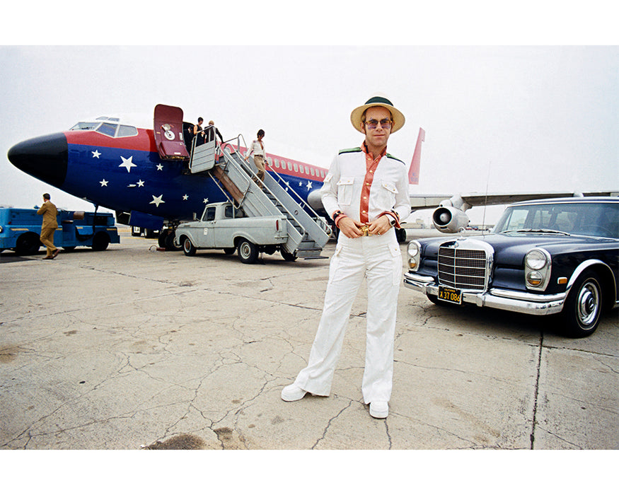 Elton John with his private plane, 1974 — Limited Edition Print - Terry O'Neill