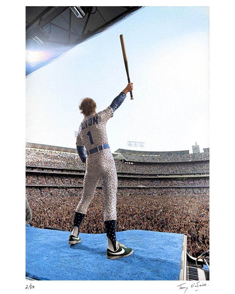 Elton John standing on a piano (colorized), 1975 — Limited Edition Print - Terry O'Neill