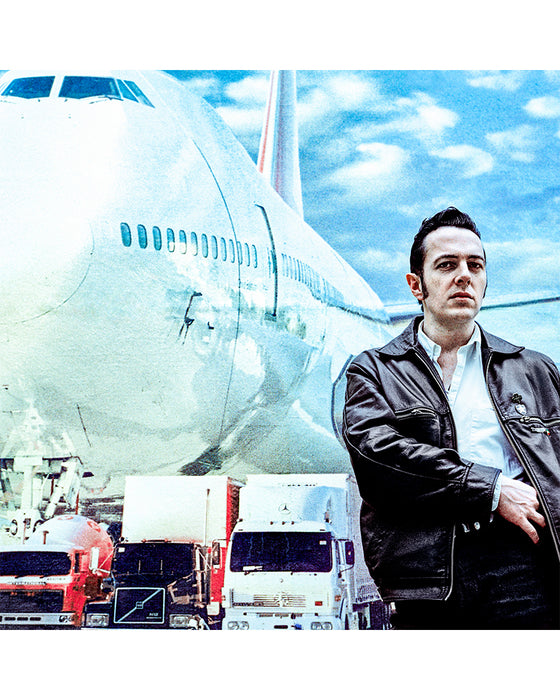 Joe Strummer in front of a plane, 1989 — Limited Edition Print - Gavin Evans