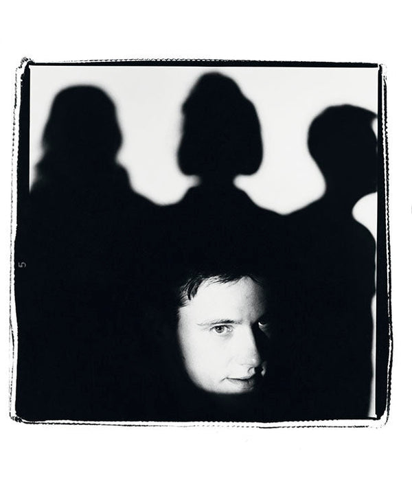 Stephen Morris with the band in shadow, 1985 — Limited Edition Print - Kevin Cummins